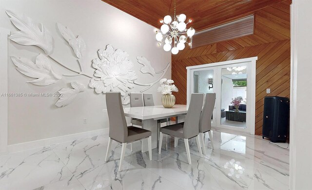 dining space featuring a chandelier, wooden walls, wooden ceiling, and vaulted ceiling