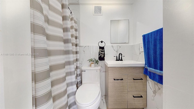 bathroom with decorative backsplash, vanity, toilet, and tile walls