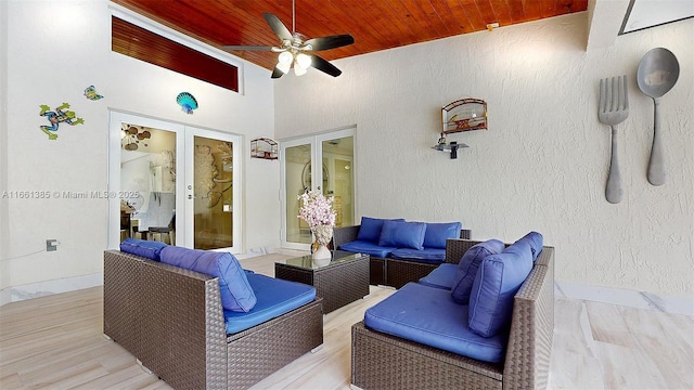 interior space featuring a wooden deck, an outdoor living space, french doors, and ceiling fan