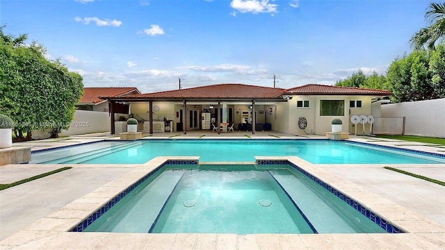 view of swimming pool featuring an in ground hot tub and a patio