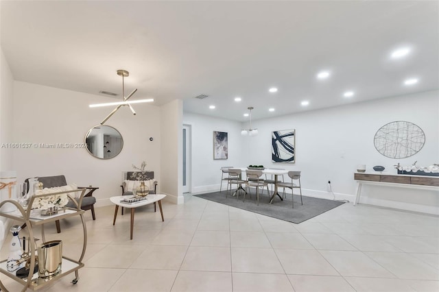 dining space featuring a chandelier and light tile patterned floors