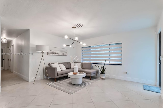 tiled living room featuring an inviting chandelier