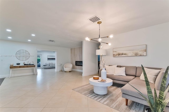 living room with a notable chandelier and light tile patterned floors