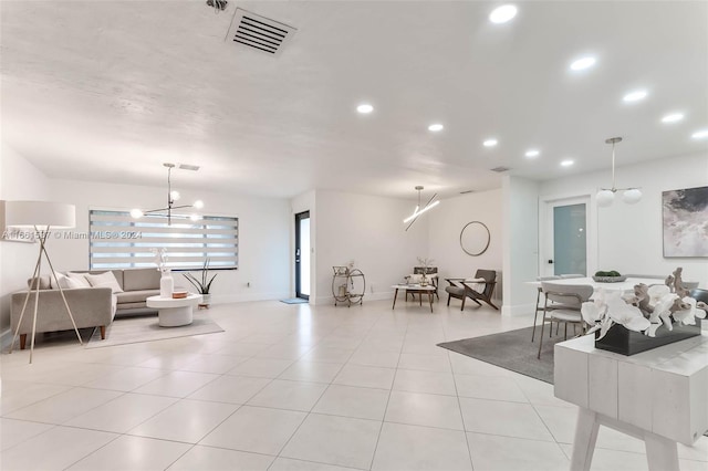 living room with a chandelier and light tile patterned floors