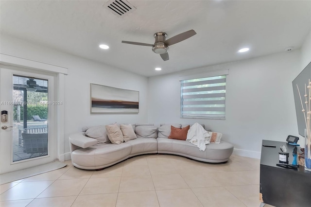 tiled living room with ceiling fan