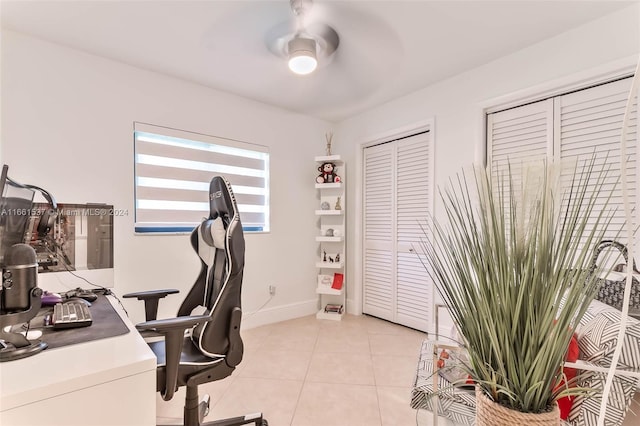 home office featuring light tile patterned flooring and ceiling fan