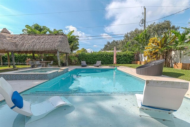 view of swimming pool featuring a gazebo, an in ground hot tub, and a patio area