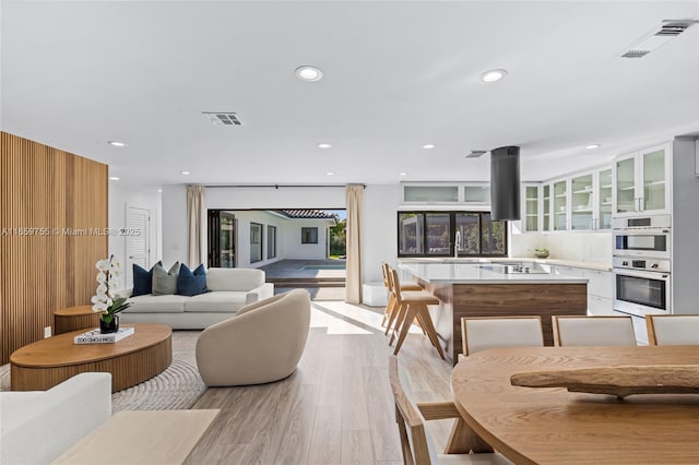 living room featuring visible vents, recessed lighting, and light wood-style floors