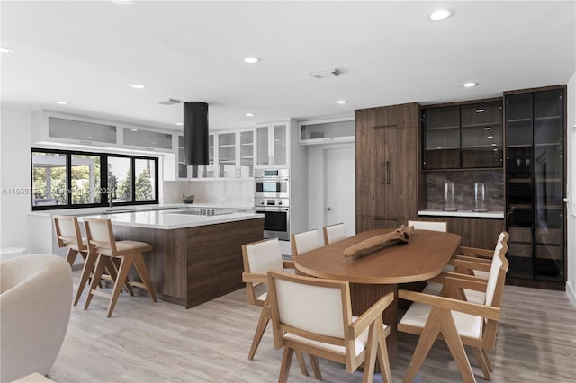 dining room with light hardwood / wood-style flooring