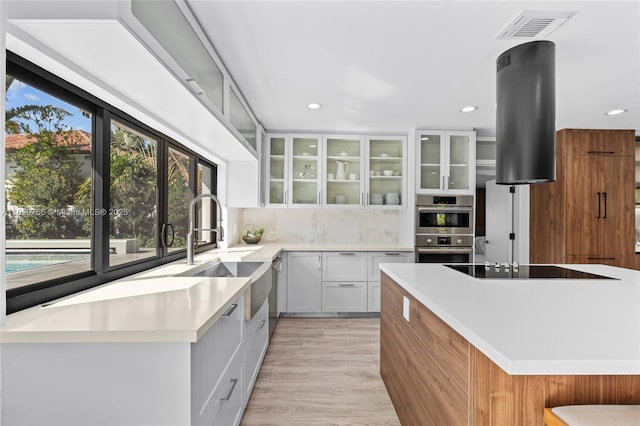 kitchen with recessed lighting, stainless steel double oven, visible vents, black electric cooktop, and a sink