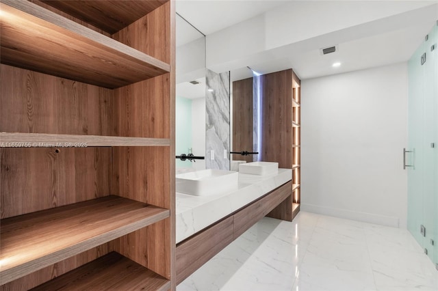 bathroom featuring visible vents, a sink, double vanity, recessed lighting, and marble finish floor
