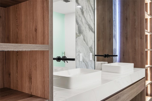 bathroom featuring double vanity and a sink