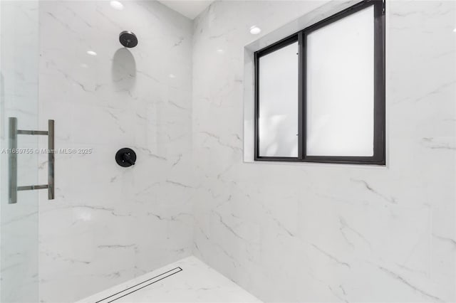 full bathroom featuring a marble finish shower