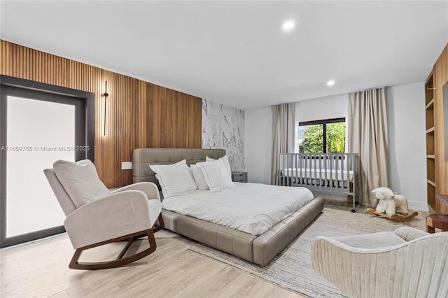 bedroom with recessed lighting and wood finished floors