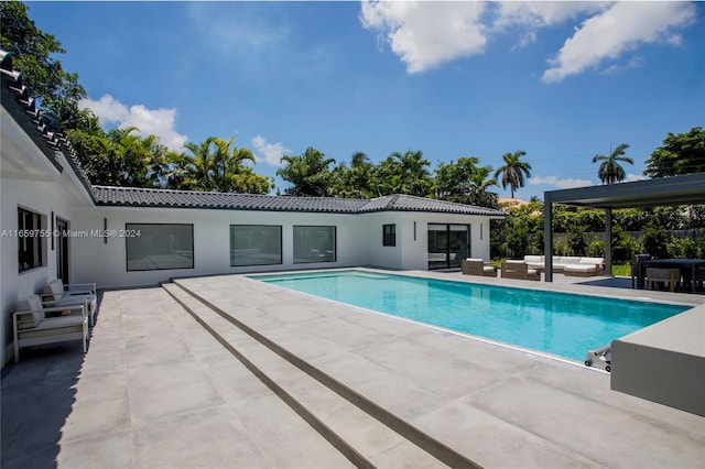 view of pool featuring an outdoor living space and a patio