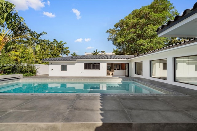 view of pool with a patio area, a fenced in pool, and fence