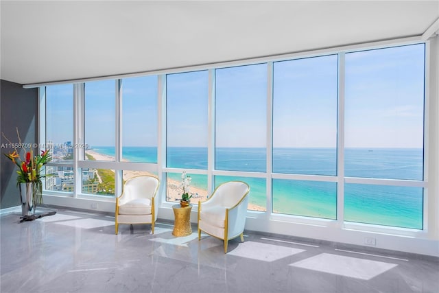 sunroom / solarium featuring a water view