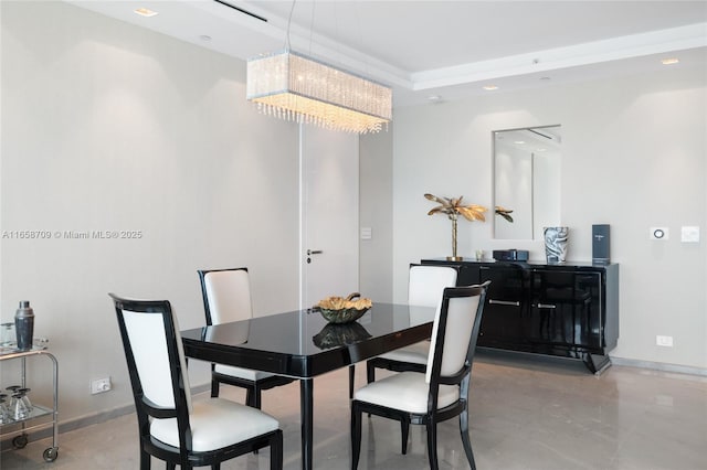 dining space with an inviting chandelier, baseboards, and finished concrete floors