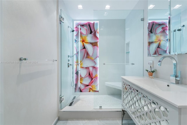 bathroom featuring vanity, a skylight, and a bathtub