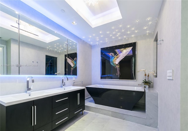 bathroom with a tub to relax in, vanity, and a skylight