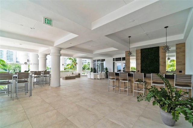 interior space with an outdoor bar and ceiling fan