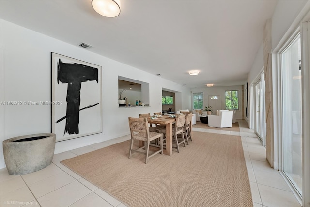 dining space featuring light tile patterned flooring