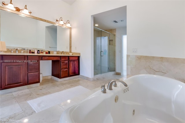 bathroom with vanity and separate shower and tub