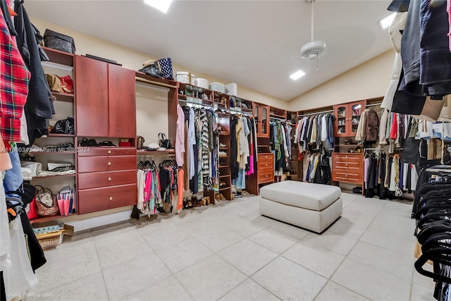 walk in closet featuring lofted ceiling and light tile patterned floors