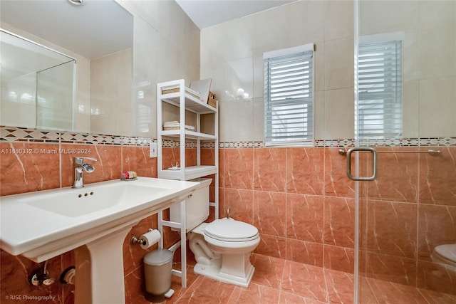 bathroom with walk in shower, tile walls, tile patterned flooring, and toilet