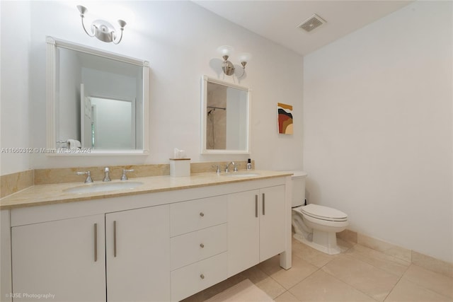 bathroom with tile patterned floors, vanity, and toilet