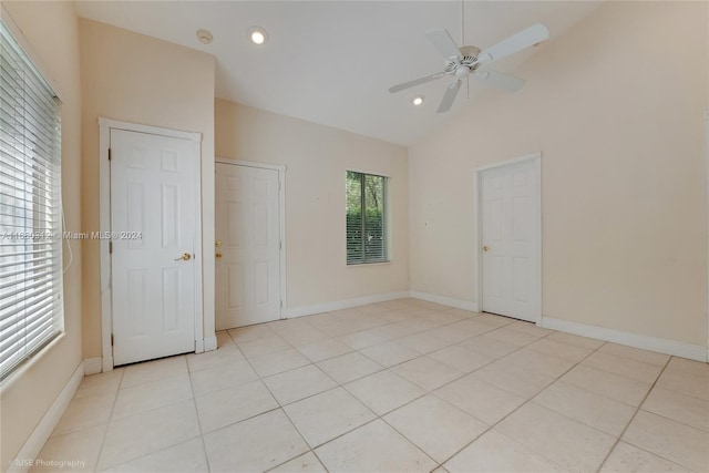 interior space featuring light tile patterned floors, ceiling fan, and high vaulted ceiling