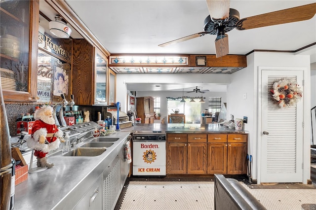 620 Tennis Club Dr Unit 111, Fort Lauderdale, FL 33311 - kitchen featuring stainless steel counters, ceiling fan, glass insert cabinets, a sink, and brown cabinetry