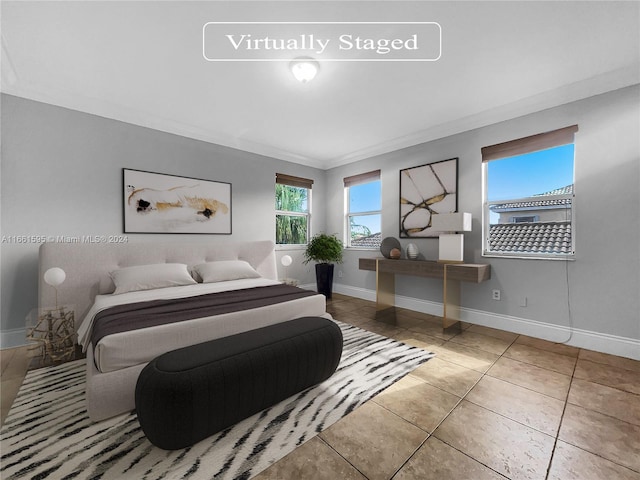 bedroom with crown molding and tile patterned flooring