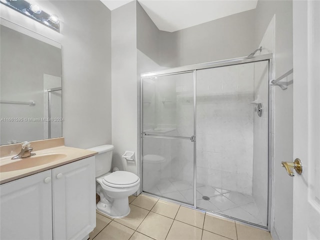 bathroom with walk in shower, vanity, toilet, and tile patterned floors