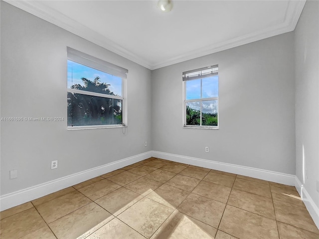 tiled spare room with crown molding