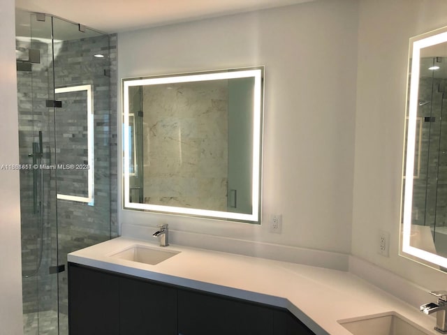 bathroom featuring an enclosed shower and vanity