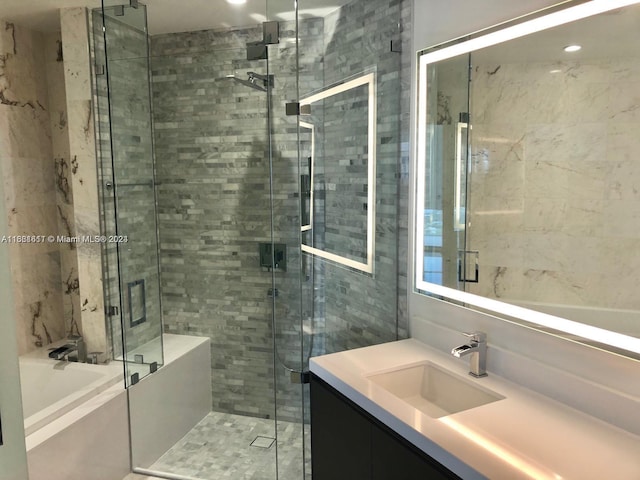 bathroom featuring vanity and plus walk in shower