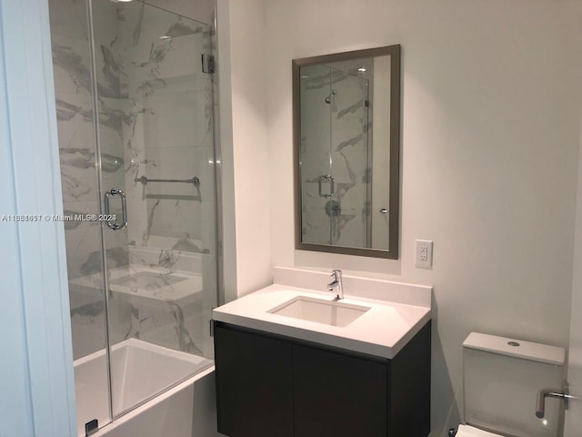 bathroom with walk in shower, vanity, and toilet