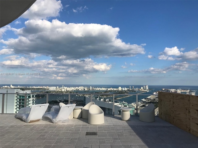 view of patio / terrace featuring a water view and a balcony