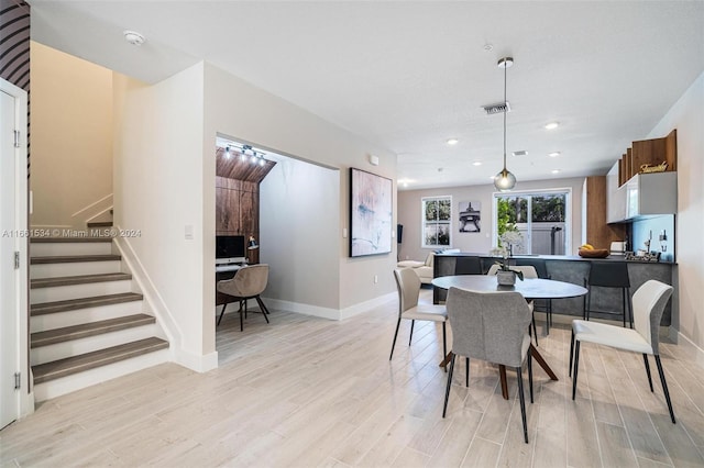 dining space with light hardwood / wood-style floors