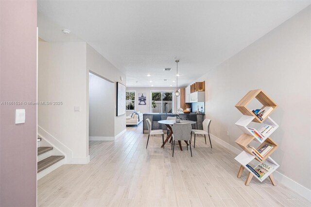 dining space featuring light wood-type flooring