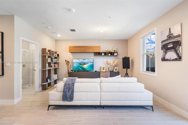 living room with a textured ceiling