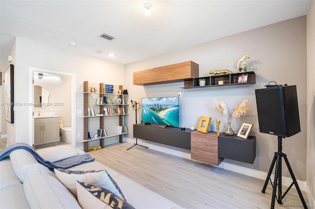 interior space featuring visible vents, baseboards, and wood finish floors