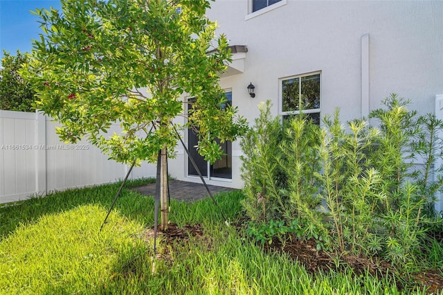 exterior space featuring stucco siding, a patio area, and fence