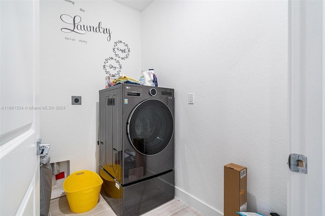 washroom with washer / clothes dryer and light hardwood / wood-style floors