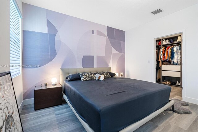 bedroom featuring wood-type flooring and a closet