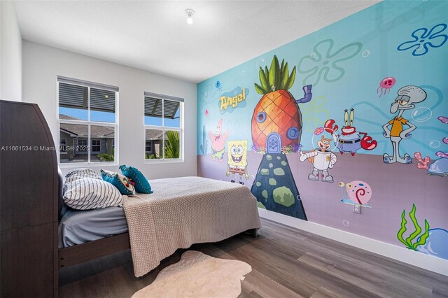 bedroom with wood-type flooring