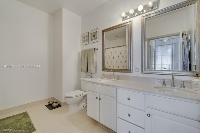 bathroom featuring toilet, vanity, tile patterned floors, and curtained shower