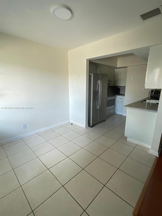 kitchen featuring white cabinetry, light tile patterned flooring, and stainless steel appliances