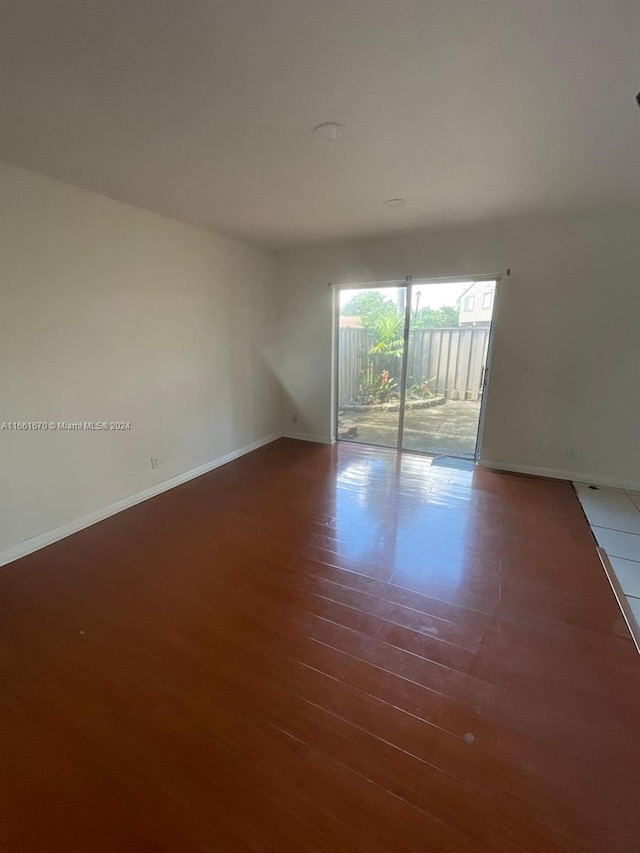 unfurnished room featuring dark wood-type flooring